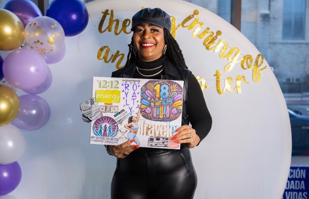 Workshop guest holding her completed vision board